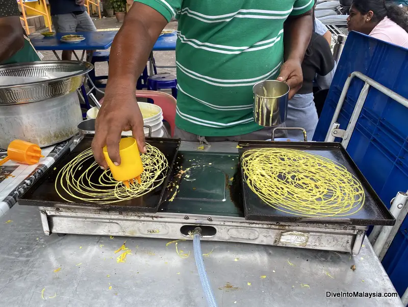 Watching them make yummy roti jala