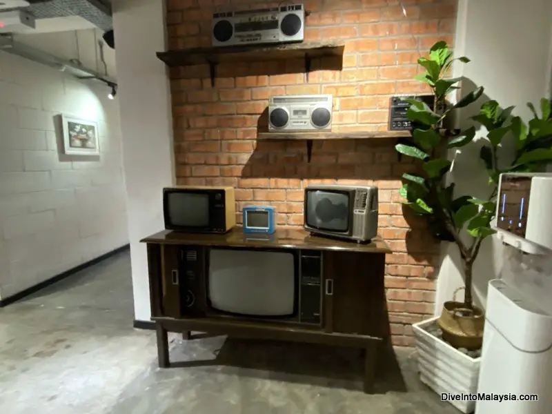 Muo Boutique Hotel entry way with old tvs and water